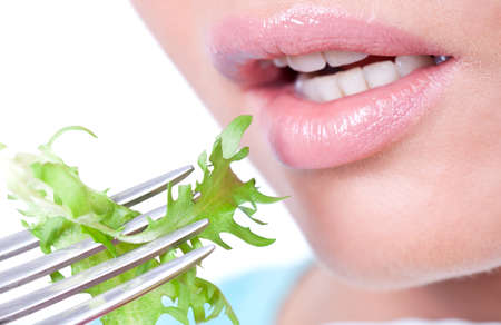 Woman eating fresh organic salad , closeupの写真素材