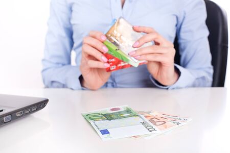Euro banknotes Ñloseup and credit cards in business woman hands, sitting in officeの写真素材