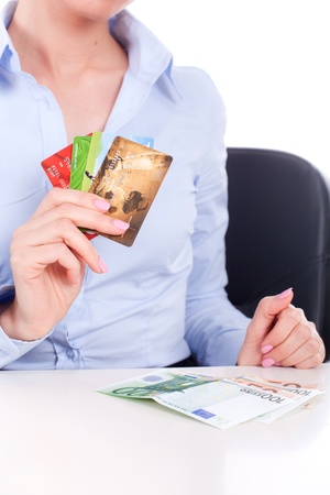 Euro banknotes closeup and credit cards in business woman hands, sitting in officeの写真素材