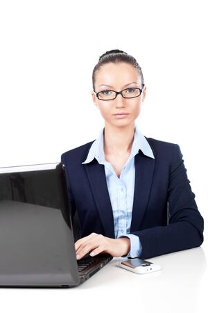 Closeup of businesswoman sitting with laptop in office の写真素材