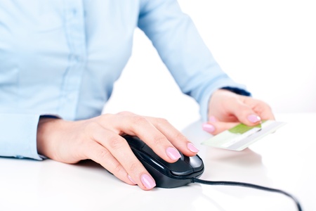 Shopping on-line, female hands holding credit card, closeupの写真素材