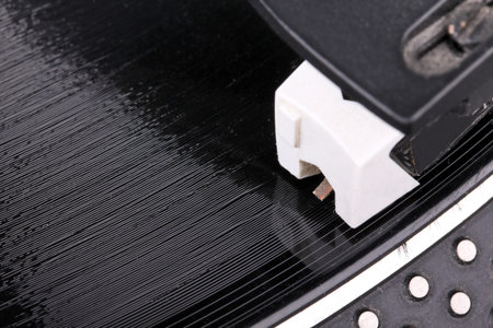 Dj needle on spinning record, closeup