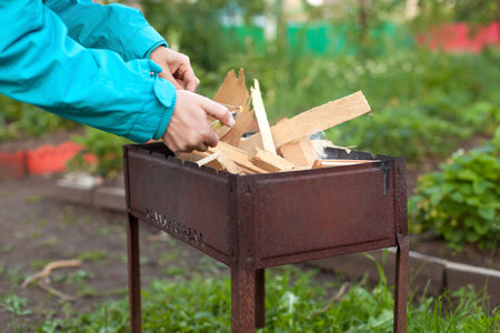Try to burn fire in barbecue, outdoors