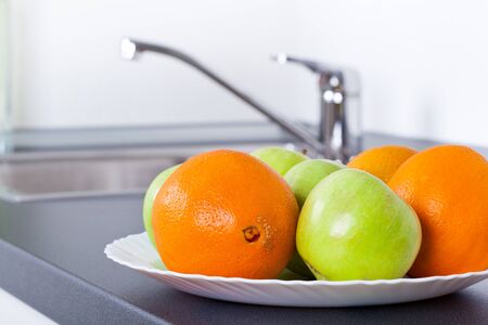 Healthy lifestyle, apples and oranges in white interior kitchenの写真素材
