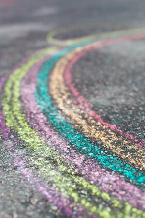 chalk drawing of rainbow and color chalks on asphaltの写真素材