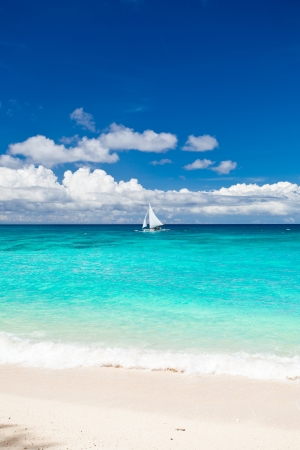Beach with sailboat in ocean, Philippinesの写真素材