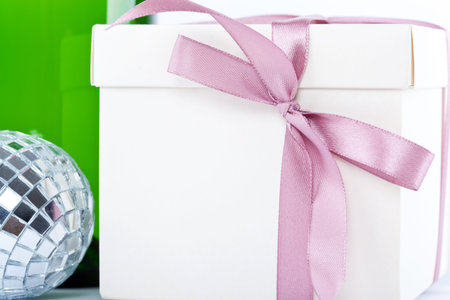 Present box with Christmas tools on white background