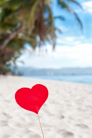 Red heart on white sand beachの写真素材