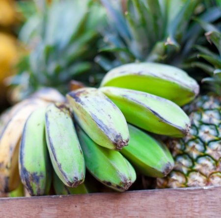 Bananas and pineapples on asian marketの写真素材
