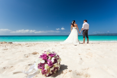 Wedding bouquet on wedding couple background, kissing at the beach
の写真素材
