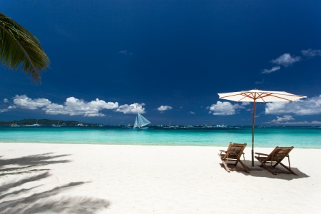 Sun umbrella and beach chairs on tropical beach, Philippines, Boracayの写真素材