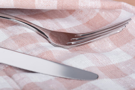 Fork and knife on towel, closeupの写真素材