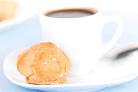 Cup of coffee on blue mat, closeup