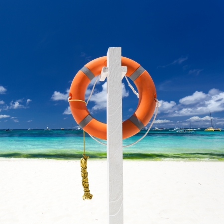 Lifebuoy ring on tropical beachの写真素材