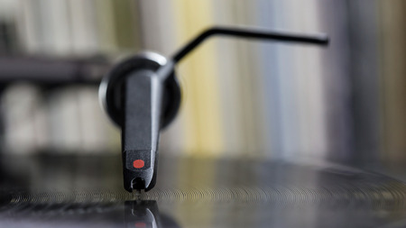 Dj needle stylus on spinning record, vinyl backgroundの写真素材