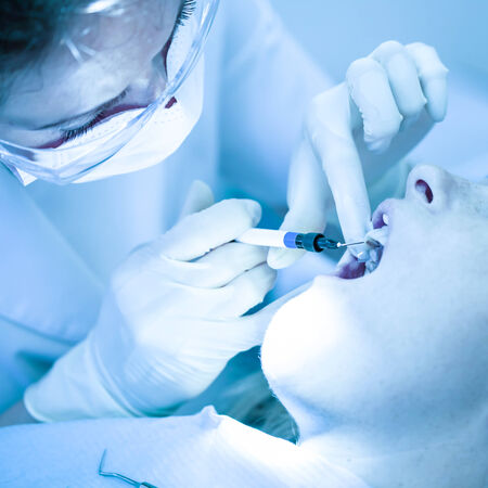 Dentist treating a female patientの写真素材