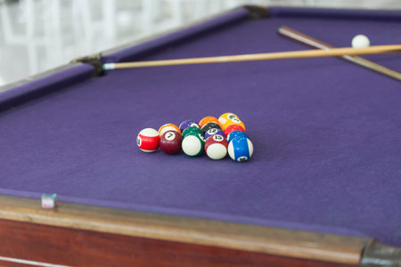 Billiard table with balls arranged in a triangle