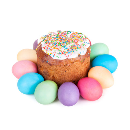 Easter cake and painted eggs closeup on white background