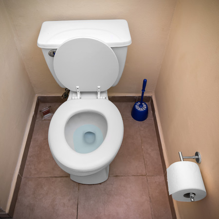 White toilet bowl and toilet paper in a bathroom interiorの写真素材
