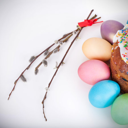 Easter cake and painted eggs closeup on white background