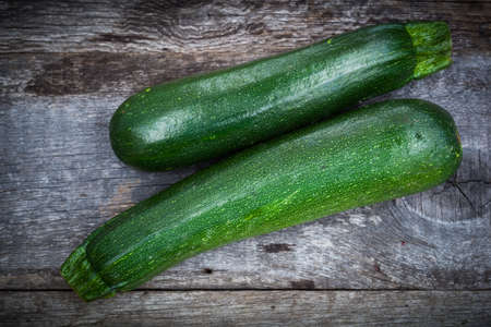 Fresh green zuchinni on wooden boardの写真素材
