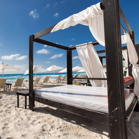 Luxury wooden lounge beds on a beautiful caribbean beachの写真素材