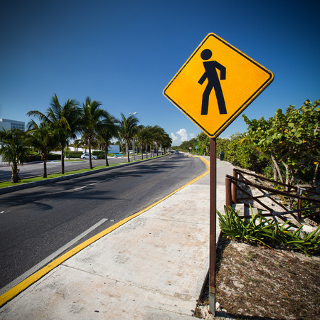 Pedestrian crossing sign on tropical streetの写真素材