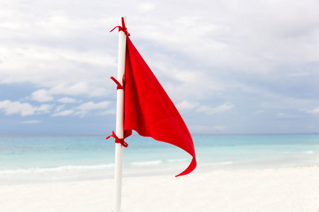 Lifeguard red flag at caribbean beach in bad weather