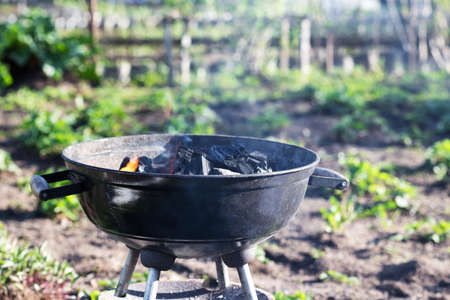 Burning charcoal in barbecue, outdoorsの写真素材