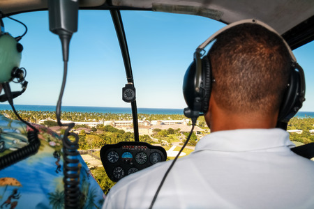Helicopter pilot in flight with tropical nature aerial viewの写真素材
