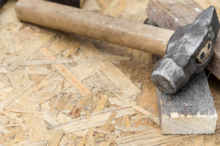 Hammer on a wooden background with copy spaceの写真素材
