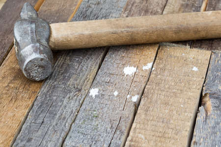 Hammer on a wooden background with copy spaceの写真素材