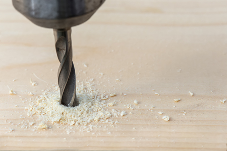 Drilling wooden plank with hand drill, closeupの写真素材