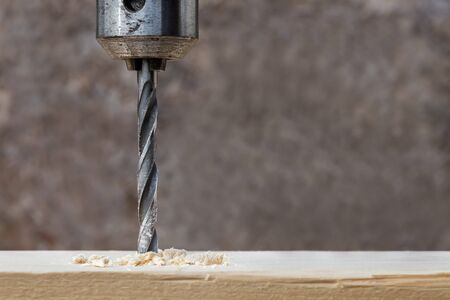 Drilling wooden plank with hand drill, closeupの写真素材