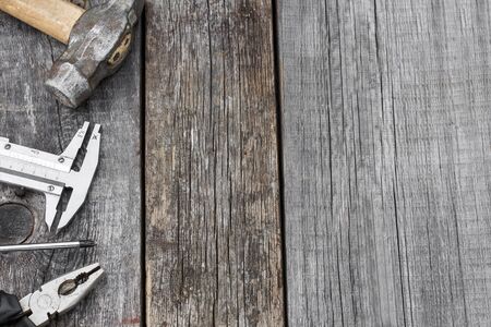 Different construction tools on a wooden background with copy spaceの写真素材