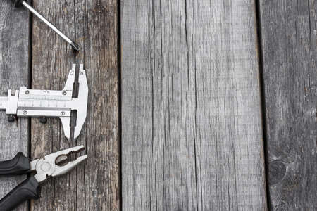 Different construction equipment on a wooden background with copy spaceの写真素材