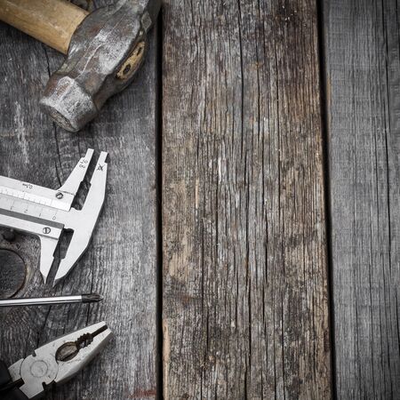 Different construction tools on a wooden background with copy spaceの写真素材