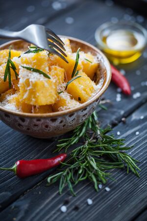 Crunchy croutons in bowl with rosemary on rustic wooden table, selective focusの写真素材