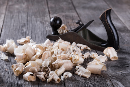 Planer and sawdust on wooden backgroundの写真素材