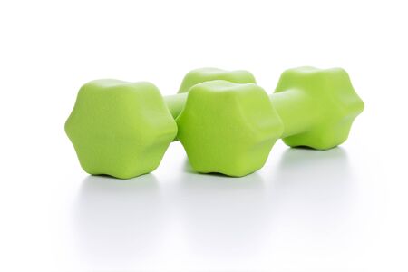 Fitness concept with two green dumbbells on white background, closeupの写真素材
