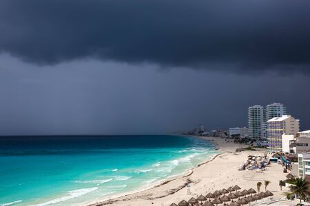 Stormy weather in Cancun, beautiful turquoise sea under dark blue clouds, view from aboveの写真素材