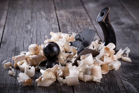 Planer and sawdust on wooden backgroundの写真素材
