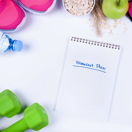 Workout plan with fitness food and equipment on white, top viewの写真素材