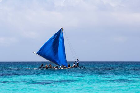 Boracay Island, Philippines - 11 November 2011: Local wooden sailing boat at the sea with peopleのeditorial素材