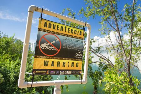 CANCUN, MEXICO - September 25, 2015: Warning crocodiles sign near the Nichupte Lagoonのeditorial素材