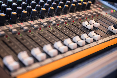 Sound mixer control panel, closeup of audio faders