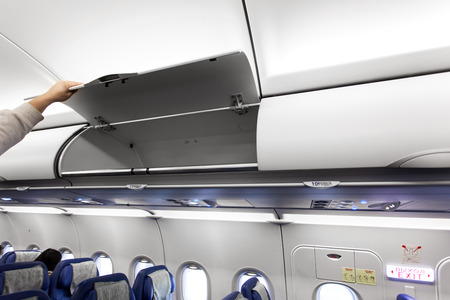 Passenger airplane interior with luggage compartmentsの写真素材