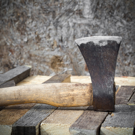Old axe on a wooden background, closeupの写真素材