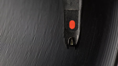 Closeup on stylus of DJ needle on spinning turntable