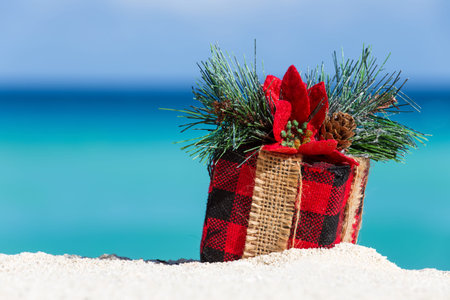 Tropical celebration on beach. Present box on sand against turquoise caribbean sea waterの写真素材